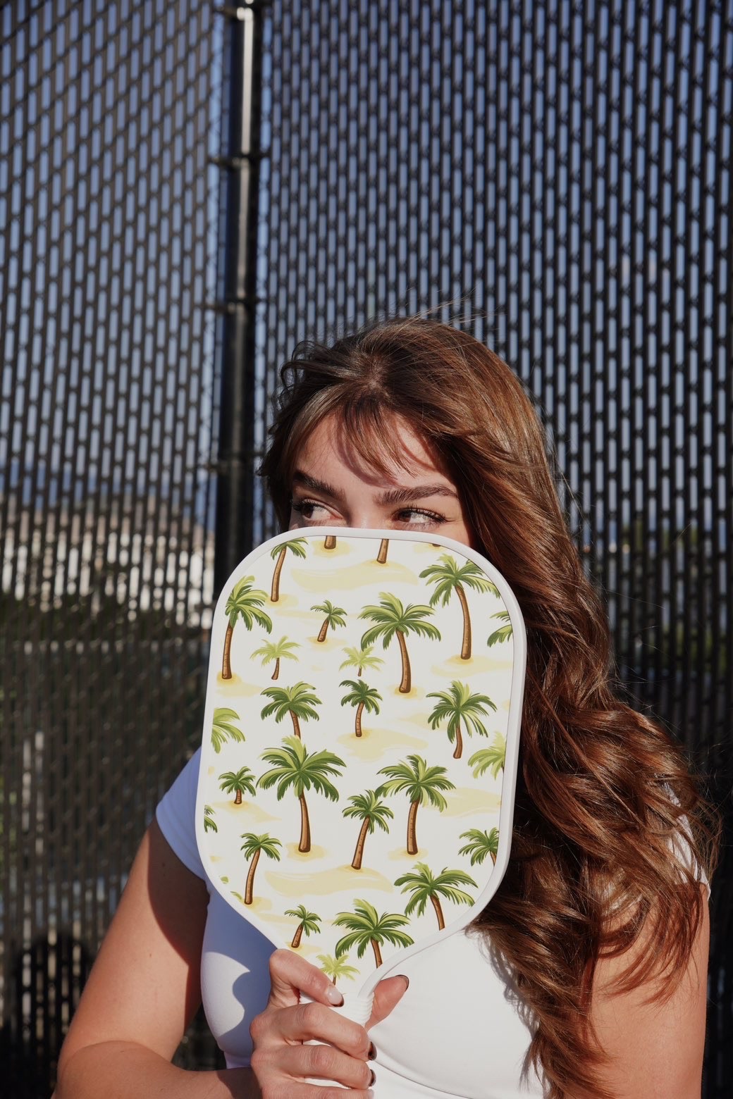 A player peeking over The Palm on a sunny court